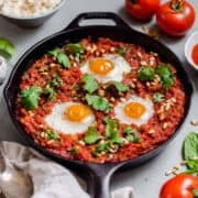 A paleo and Whole30 easy shakshuka recipe that's perfect for breakfast, lunch or dinner. This shakshuka recipe is served over a bed of cauliflower rice and is grain free, dairy free and absolutely delicious! #whole30 #whole30recipes #paleo #shakshuka