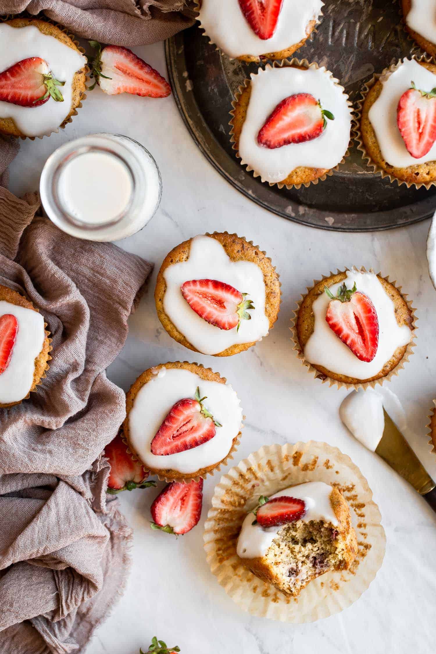 keto strawberry muffins with a linen napkin and glass of milk
