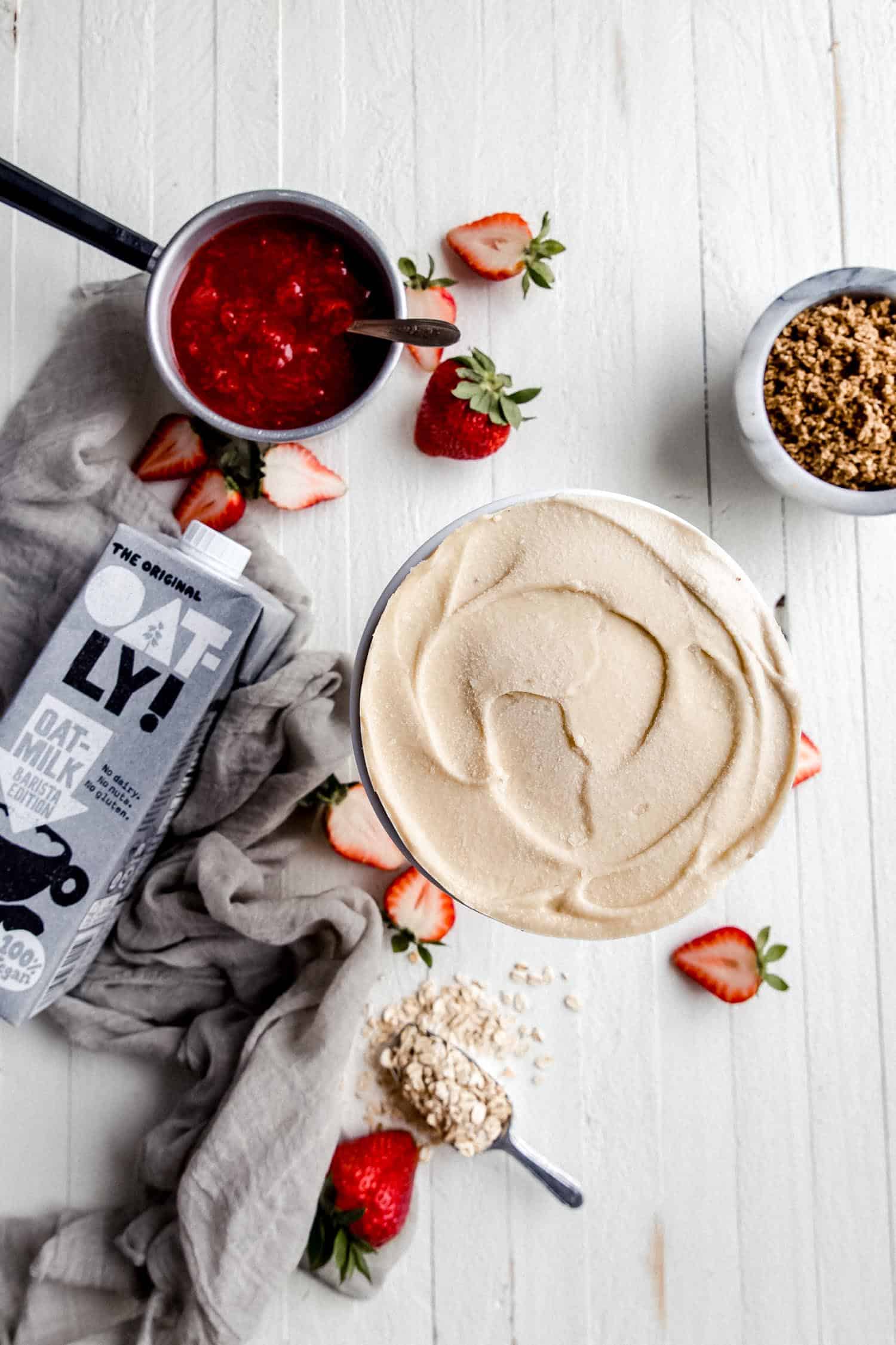 vegan cheesecake on a white board with strawberries