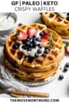 stack of paleo waffles topped with berries and whipped cream