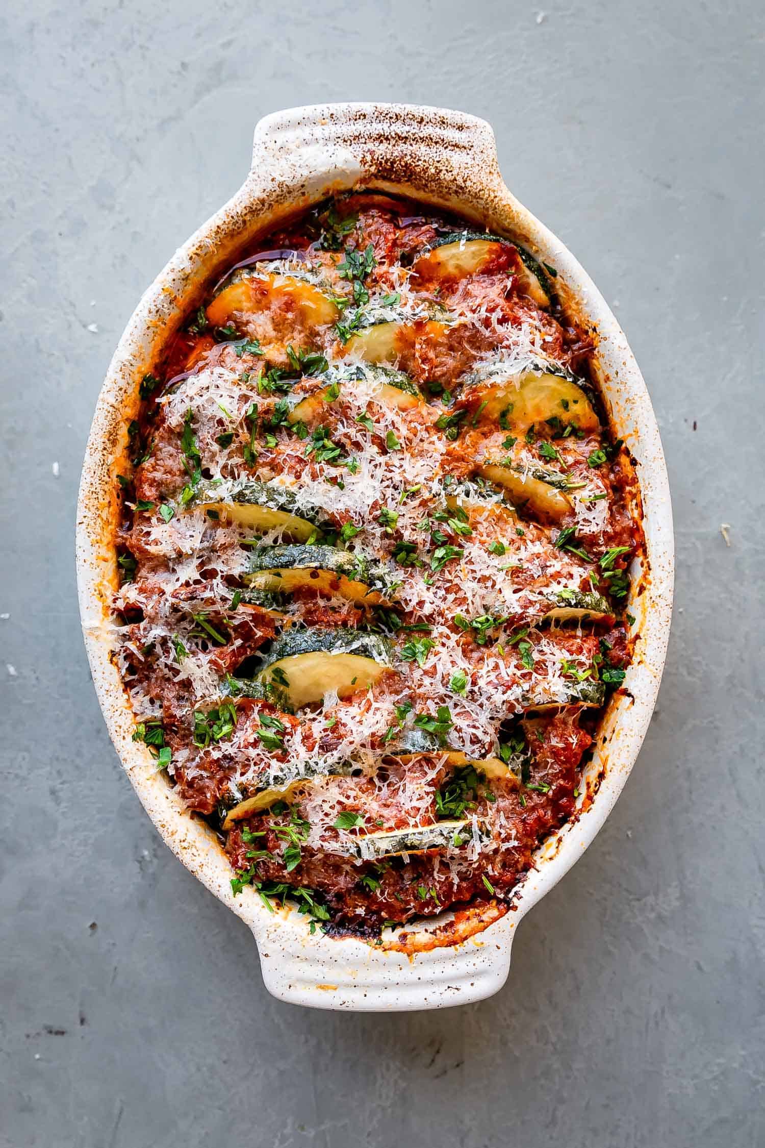 low carb zucchini casserole with red sauce and parmesan cheese on top