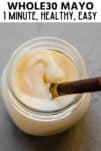 paleo mayo in a glass jar with a wooden spoon inside