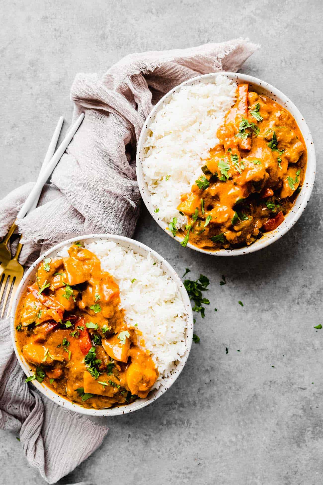 two bowls of vegan Thai curry with a linen napkin
