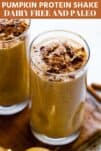 two glasses of pumpkin smoothies topped with nuts