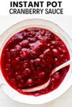 Instant Pot cranberry sauce in a white bowl with a spoon