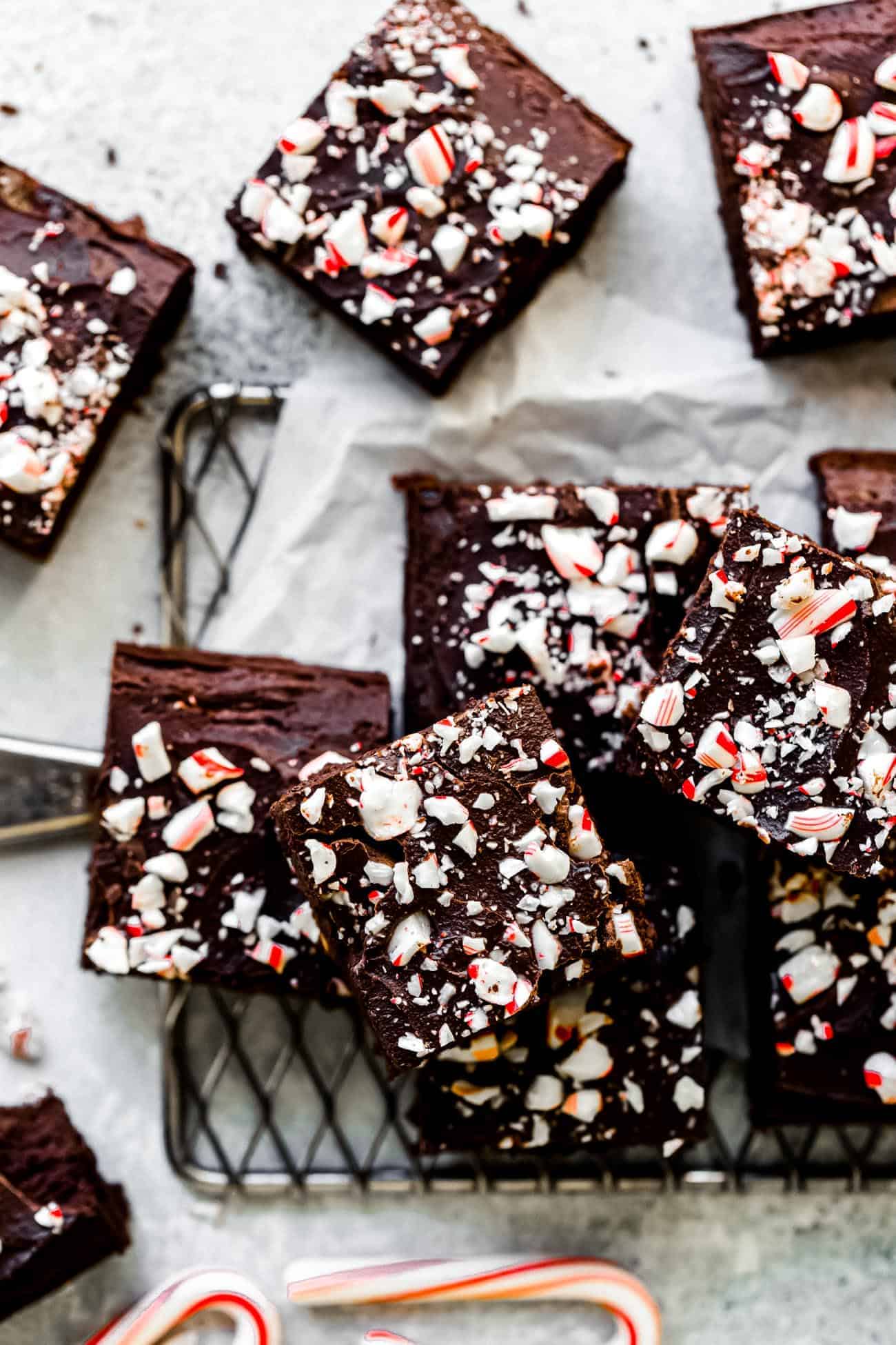 paleo flourless brownies with crushed candy canes on top on a wire rack