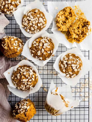 pumpkin muffins on a wire rack with oats on top