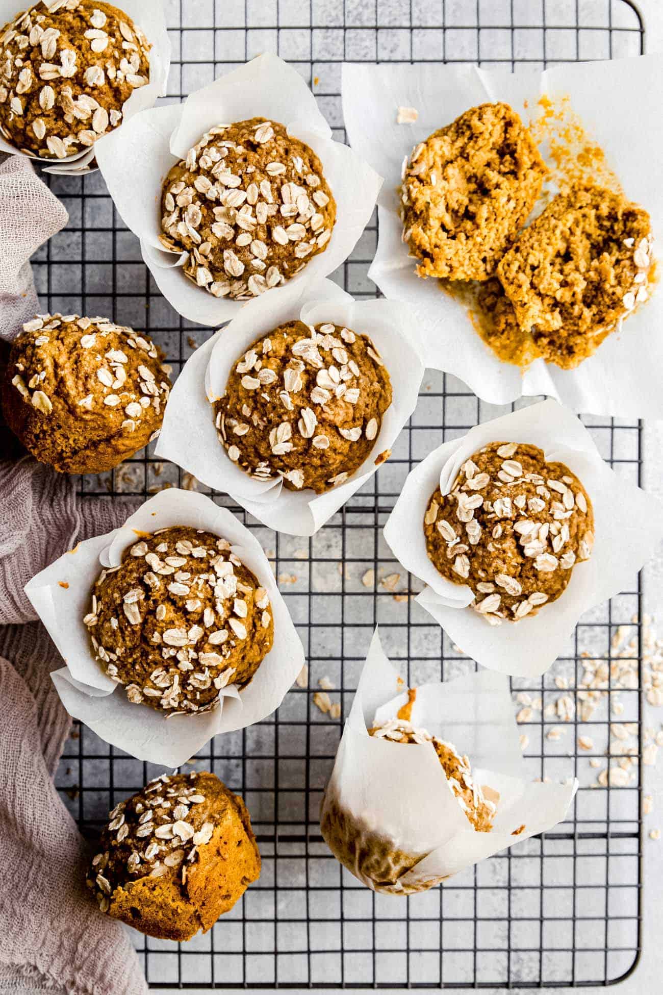 pumpkin muffins on a wire rack with oats on top