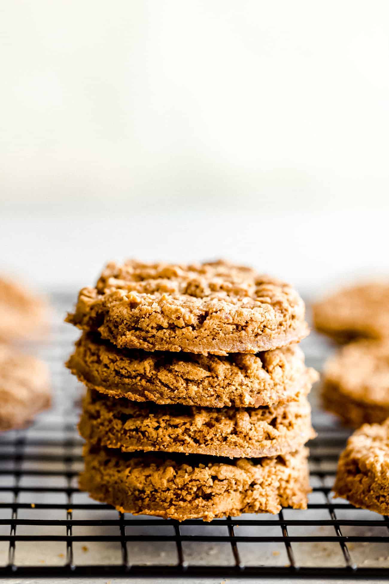 peanut butter cookies stacked on top of a wire rack
