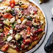 low carb pizza on a vented rack with antipasti on top