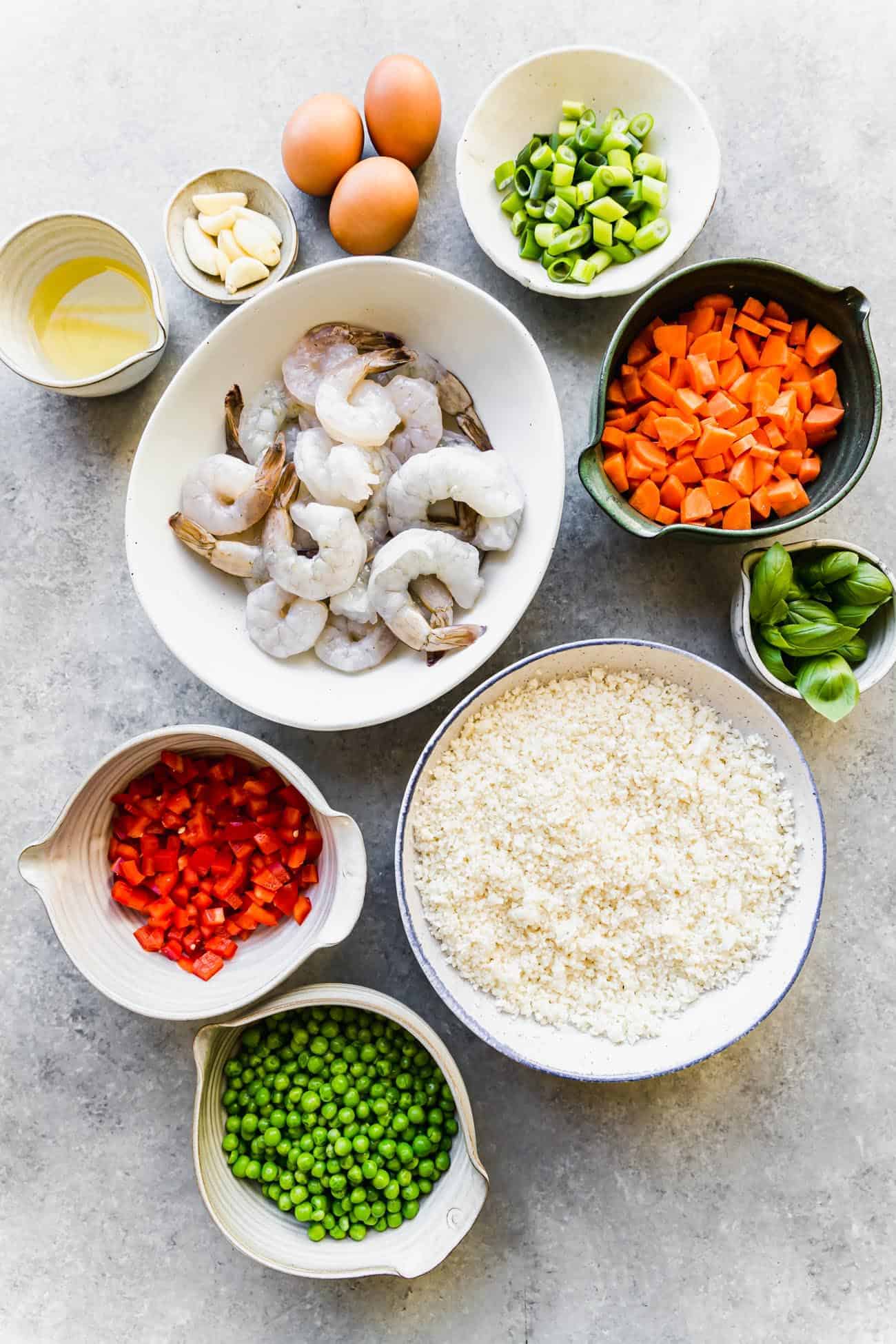 ingredients in bowls to make cauliflower rice with shrimp