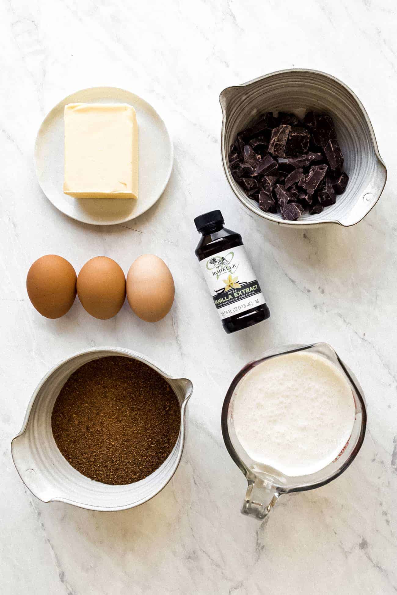 ingredients on a marble board to make chocolate buttercream frosting