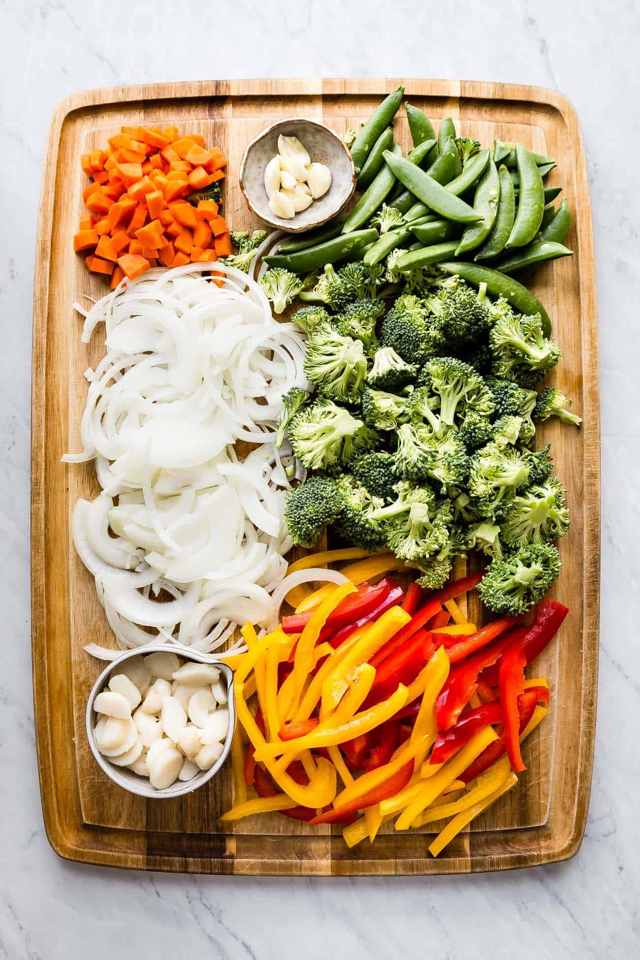 sliced veggies on a wooden cutting board