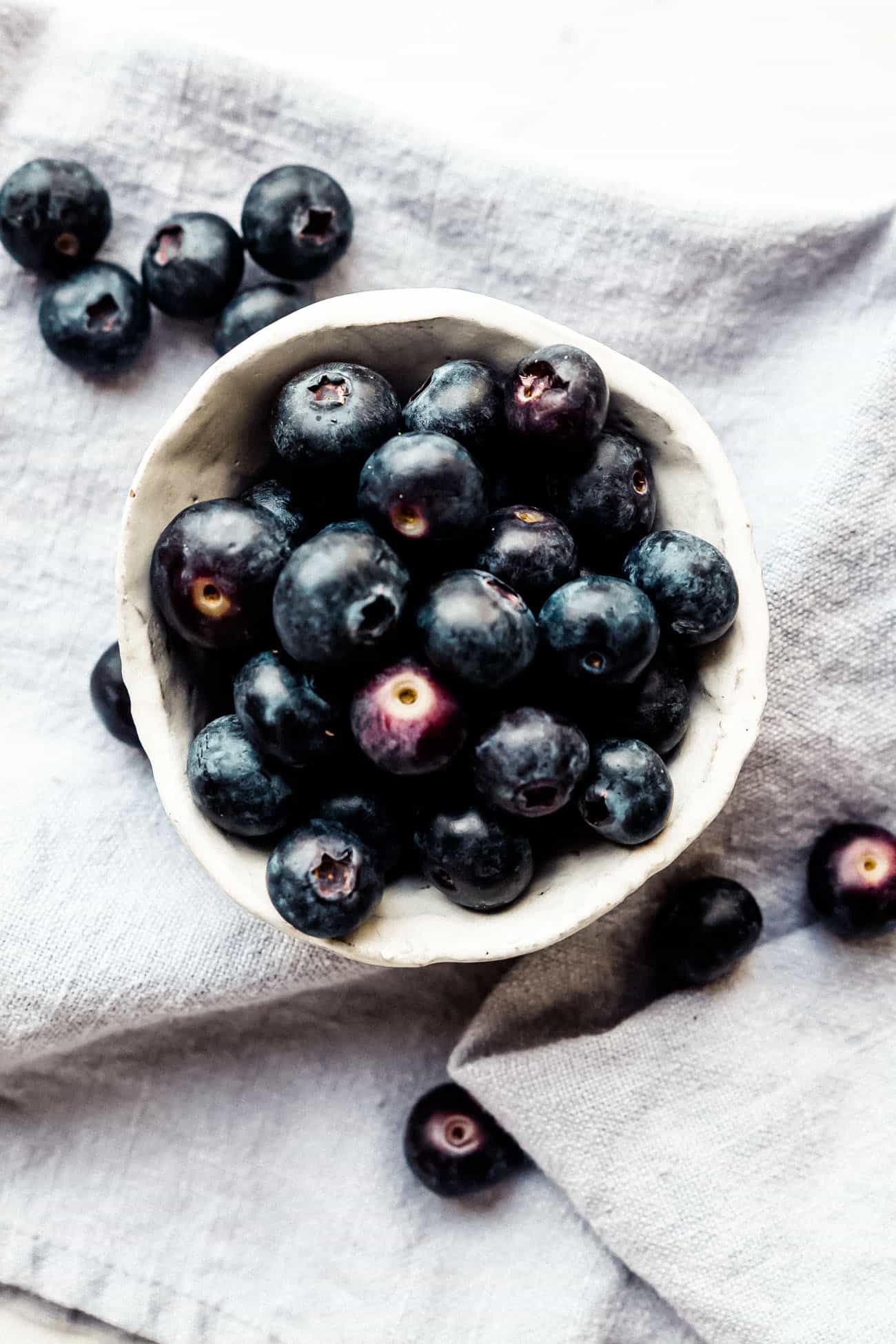 small ceramic white bowl full of fresh blueberries