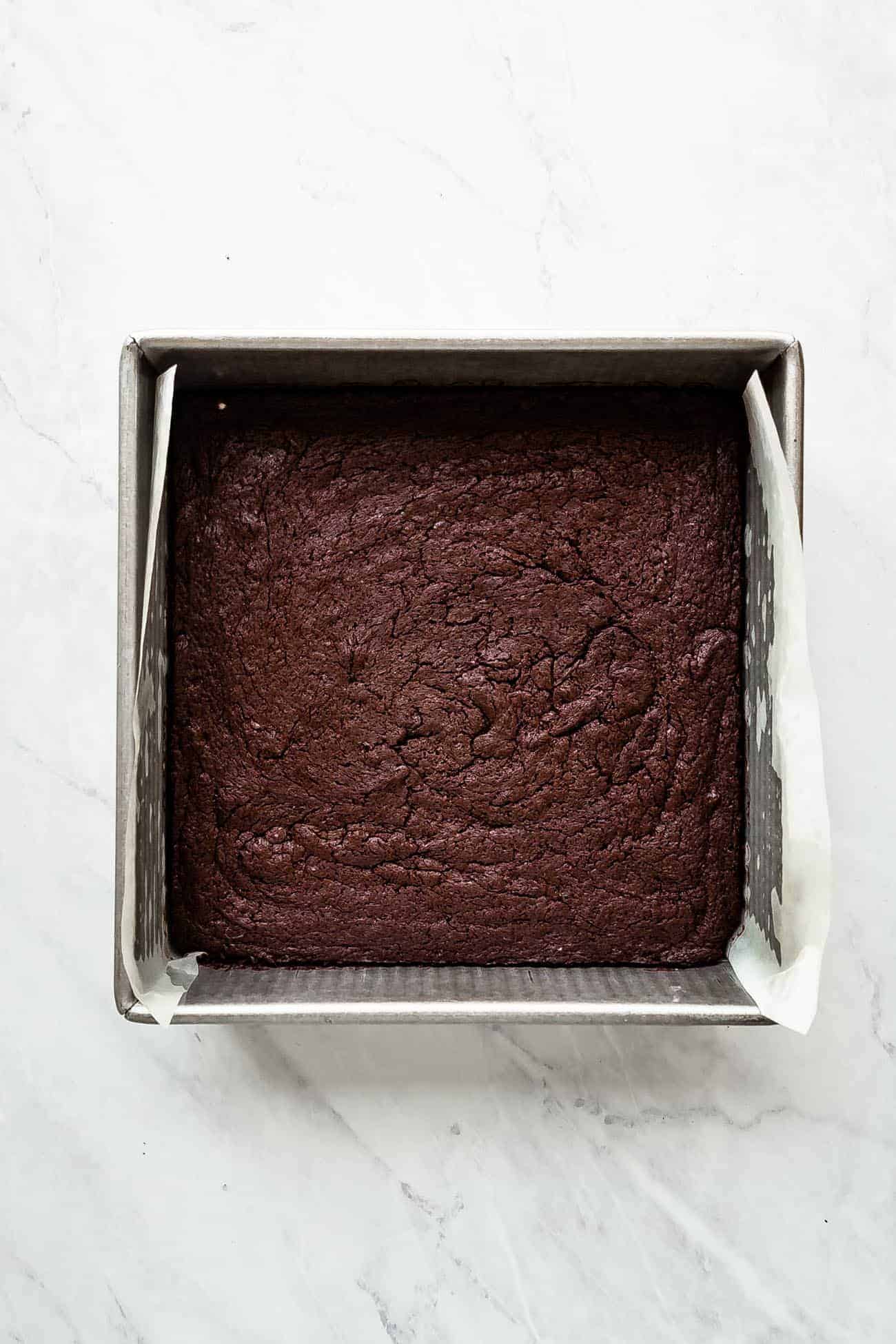 brownies in a baking pan before being cut