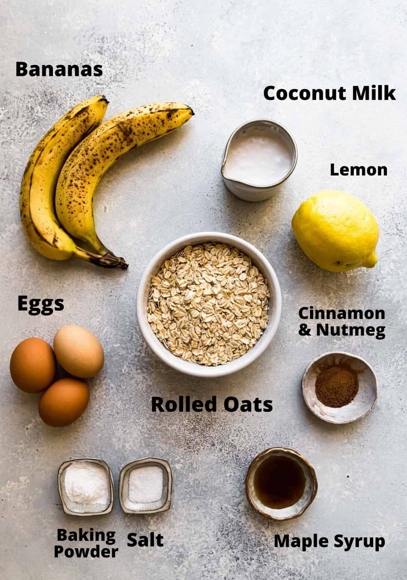 ingredients needed to make oat flour pancakes: bananas, coconut milk, lemon, eggs, cinnamon, nutmeg, rolled oats, baking powder, salt, maple syruo