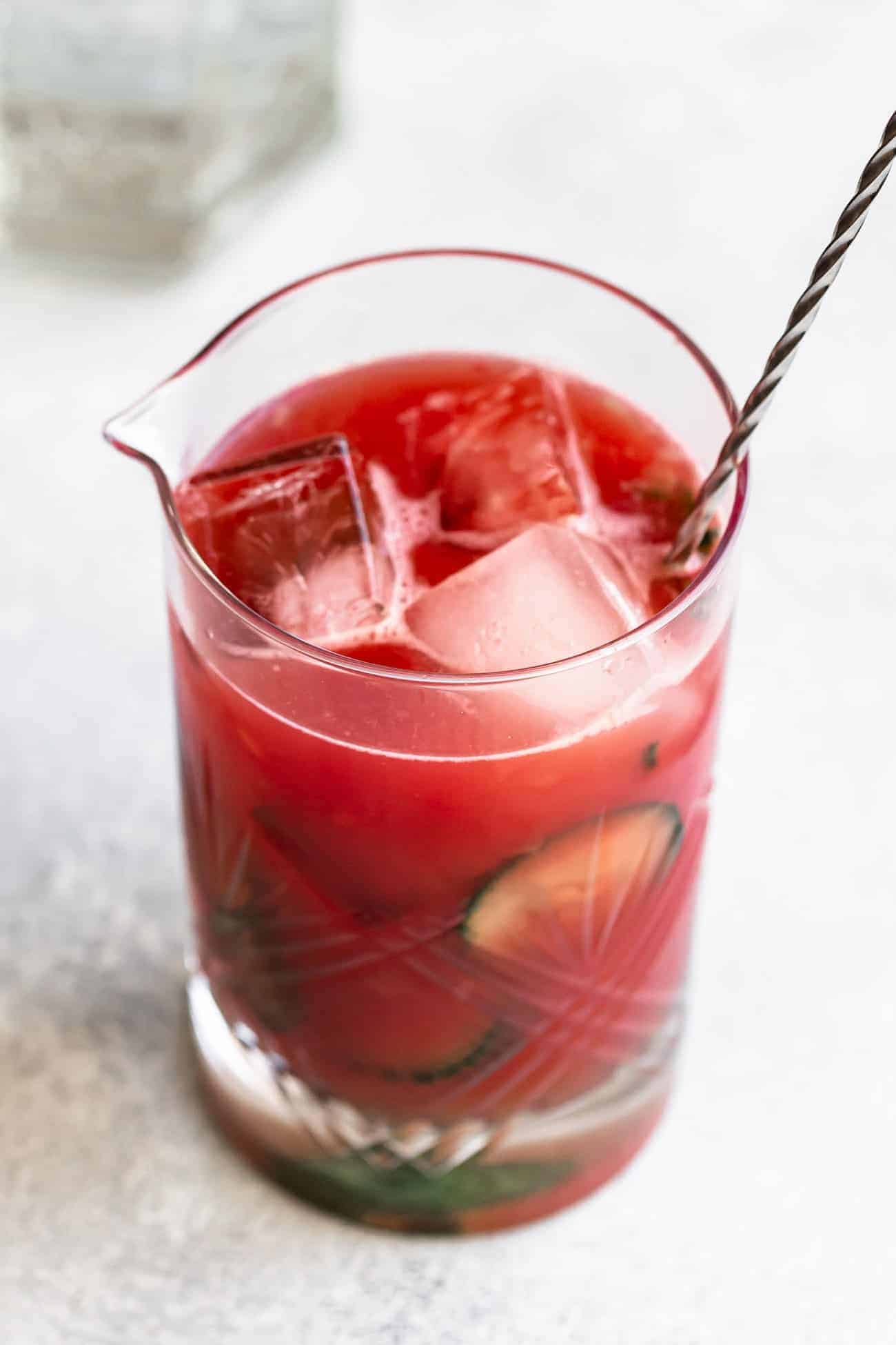 watermelon cocktail with a stirring spoon in a glass container