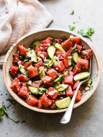 watermelon and feta salad in a bowl with basil and mint