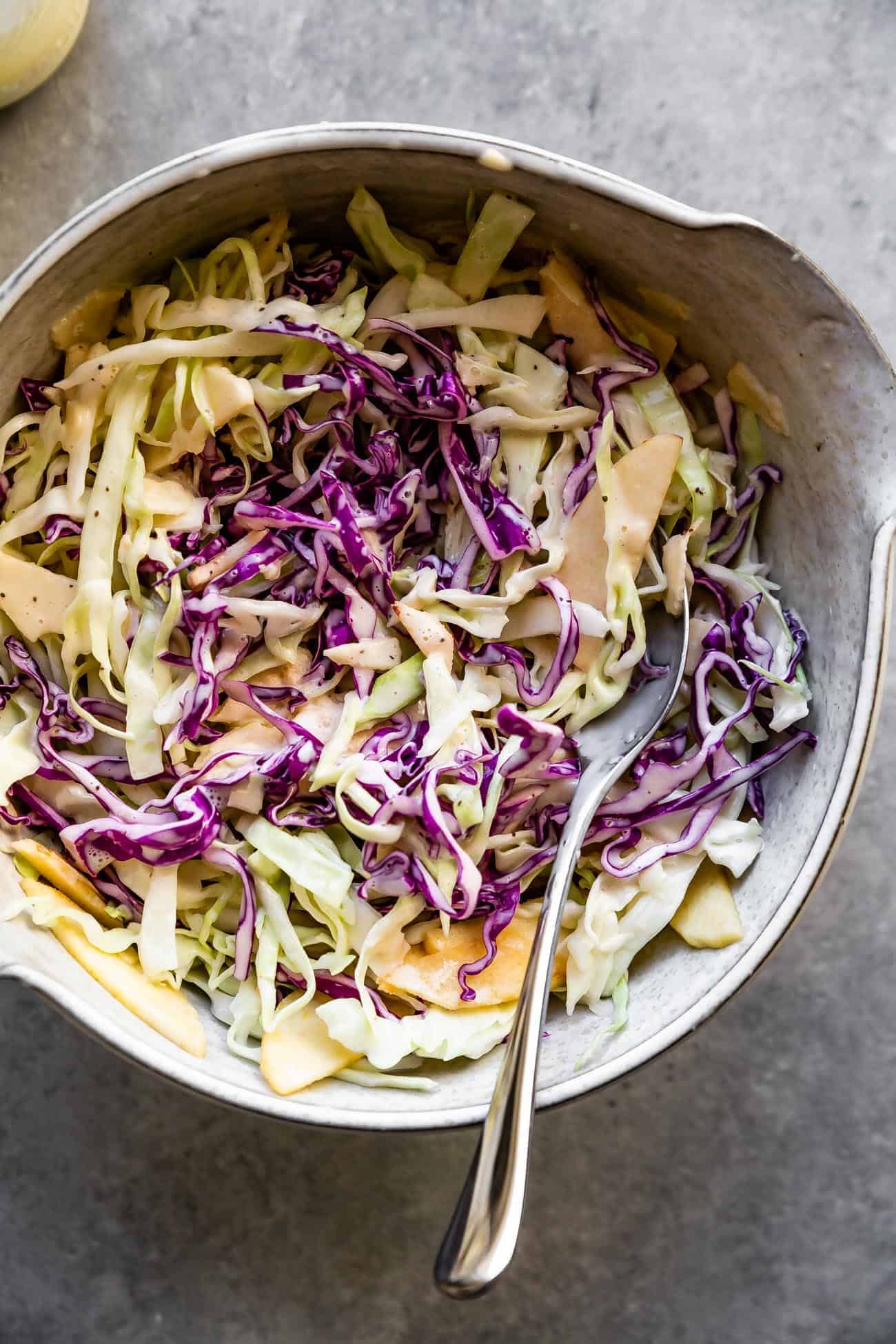 keto coleslaw in a ceramic bowl with a fork