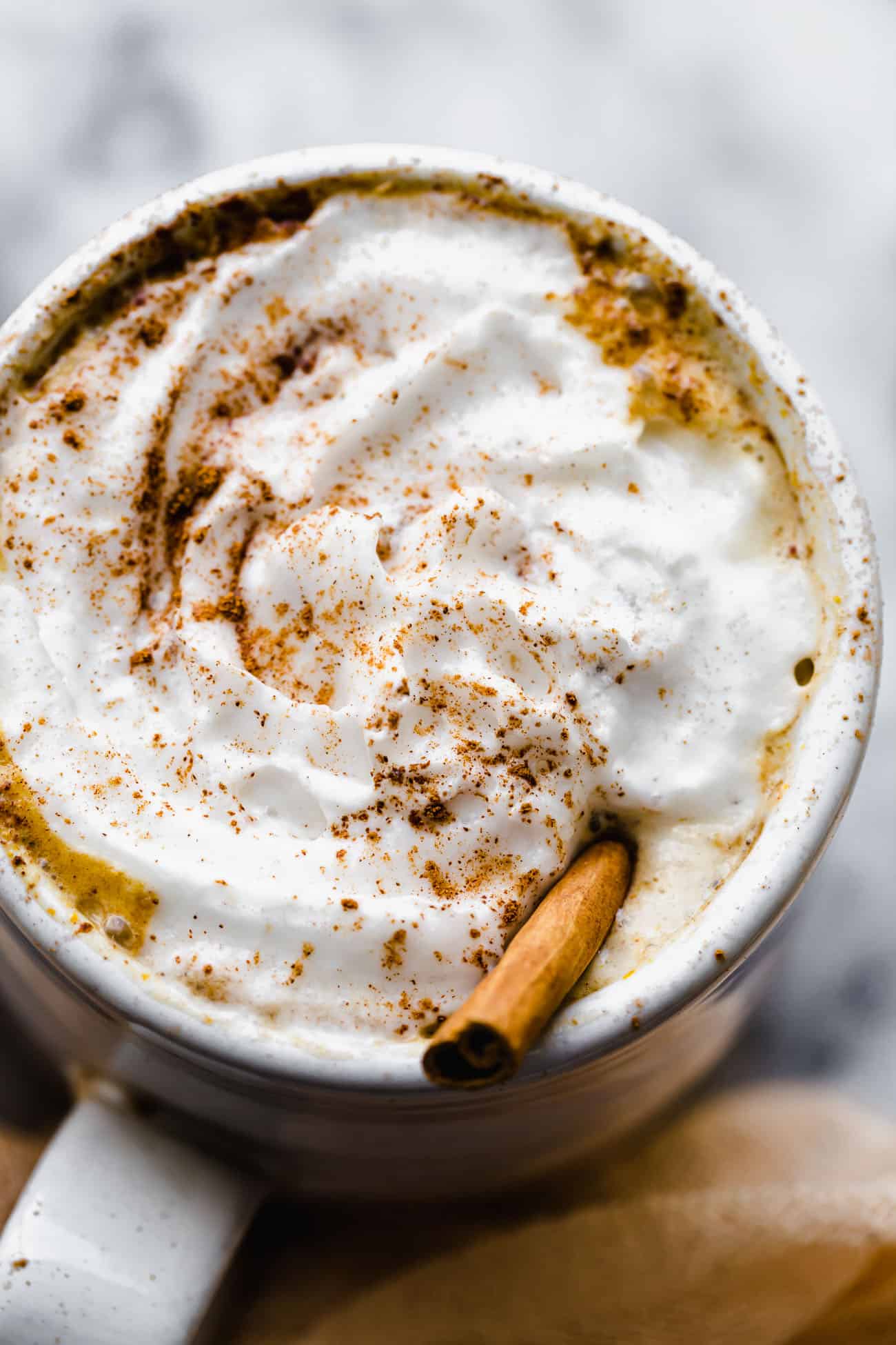 whipped cream on top of a vegan pumpkin spice latte