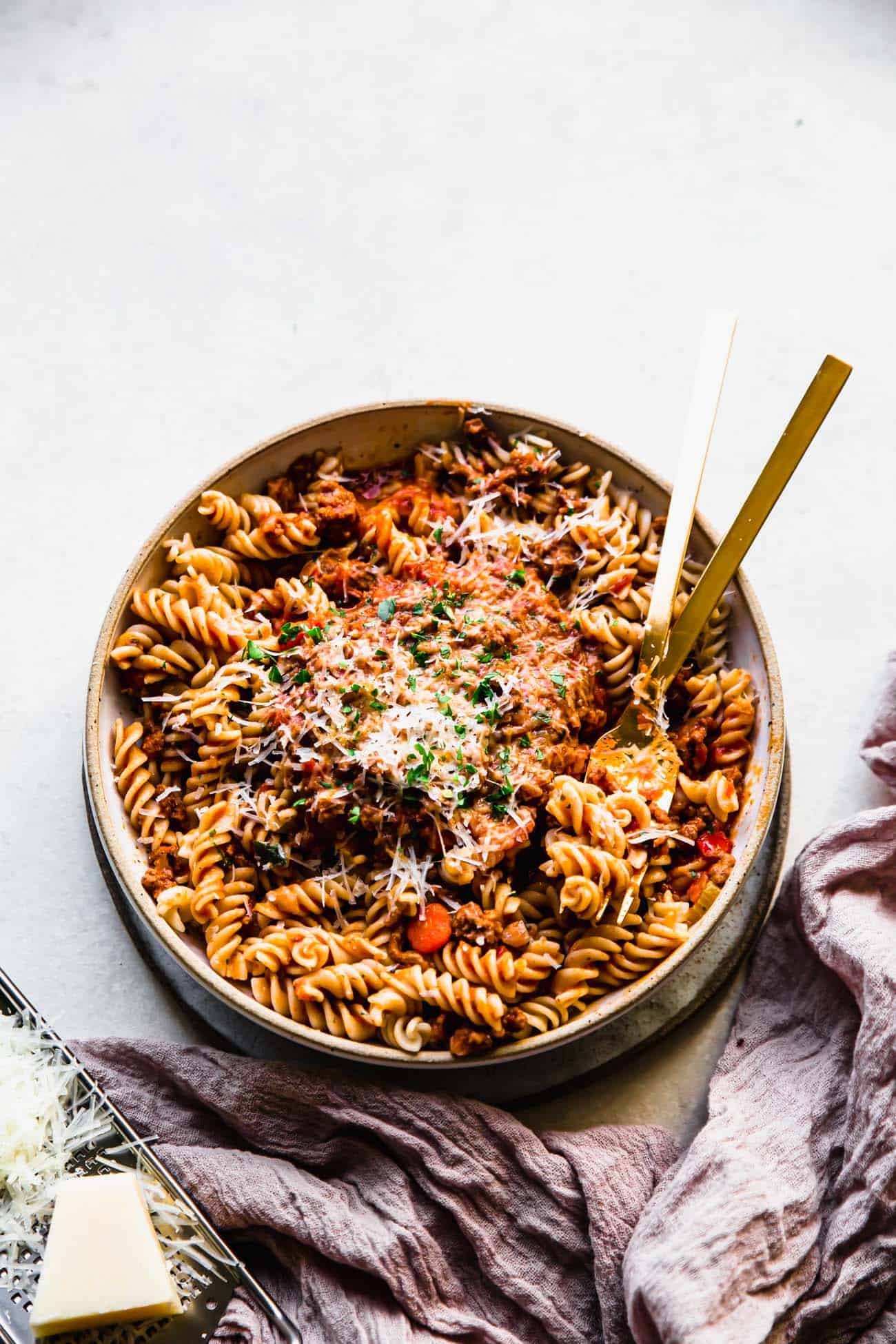 instant pot bolognese in a bowl with pasta and a gold fork