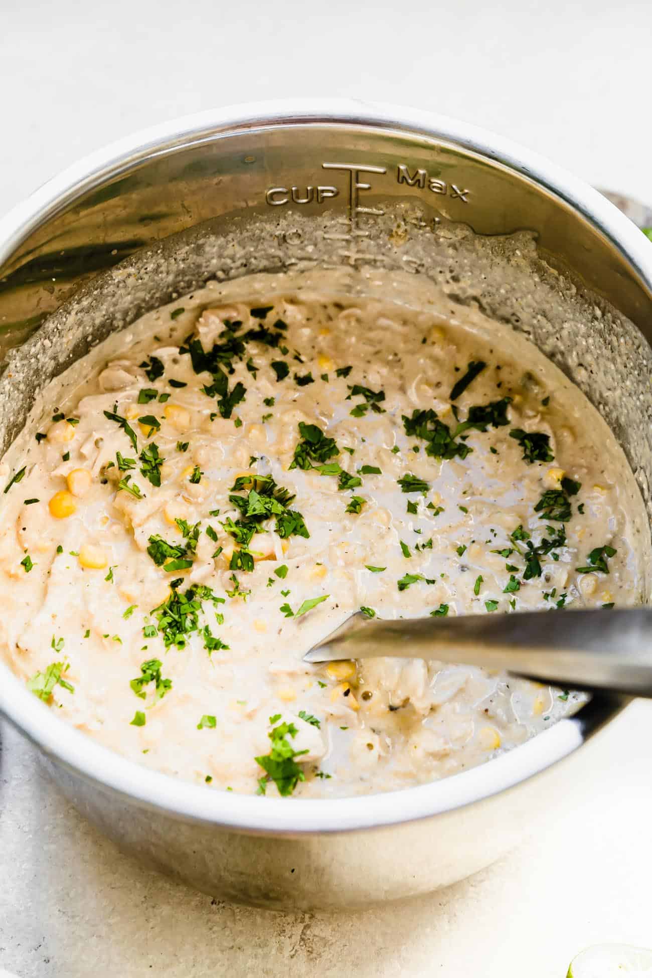 white chicken chili in an Instant Pot insert with cilantro