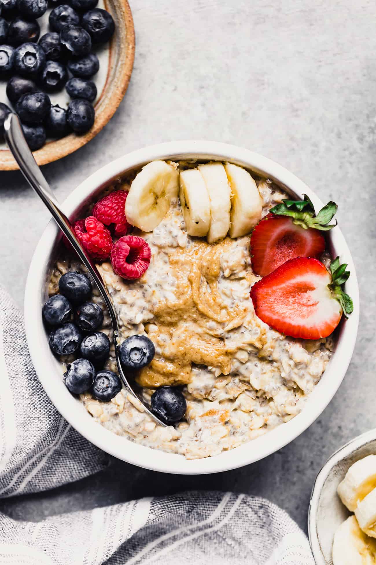 overnight oats in a bowl with peanut butter, berries and bananas