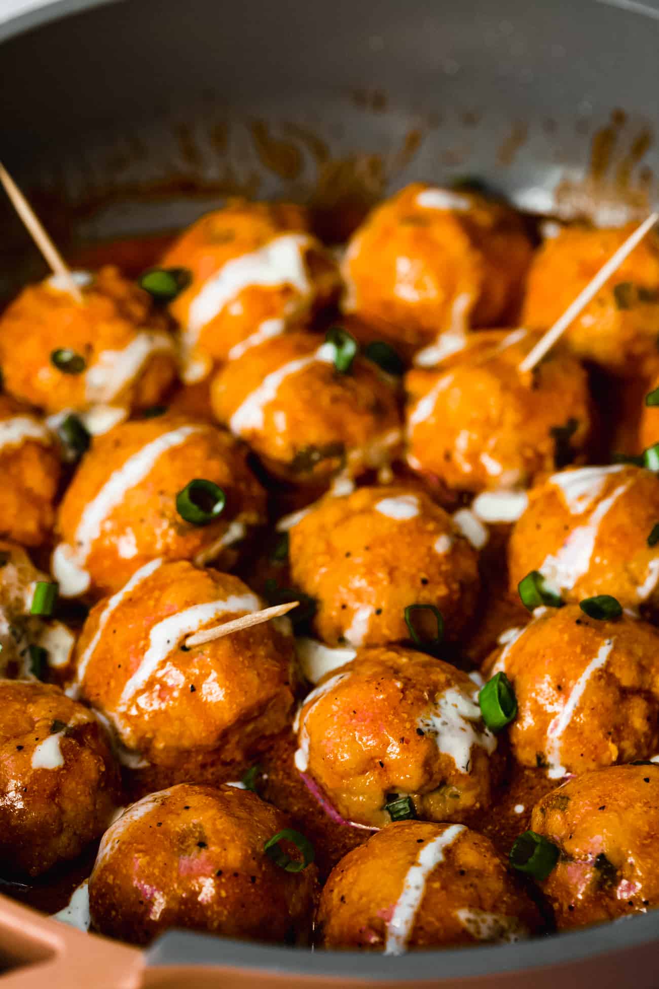 buffalo chicken meatballs with ranch drizzle and green onions