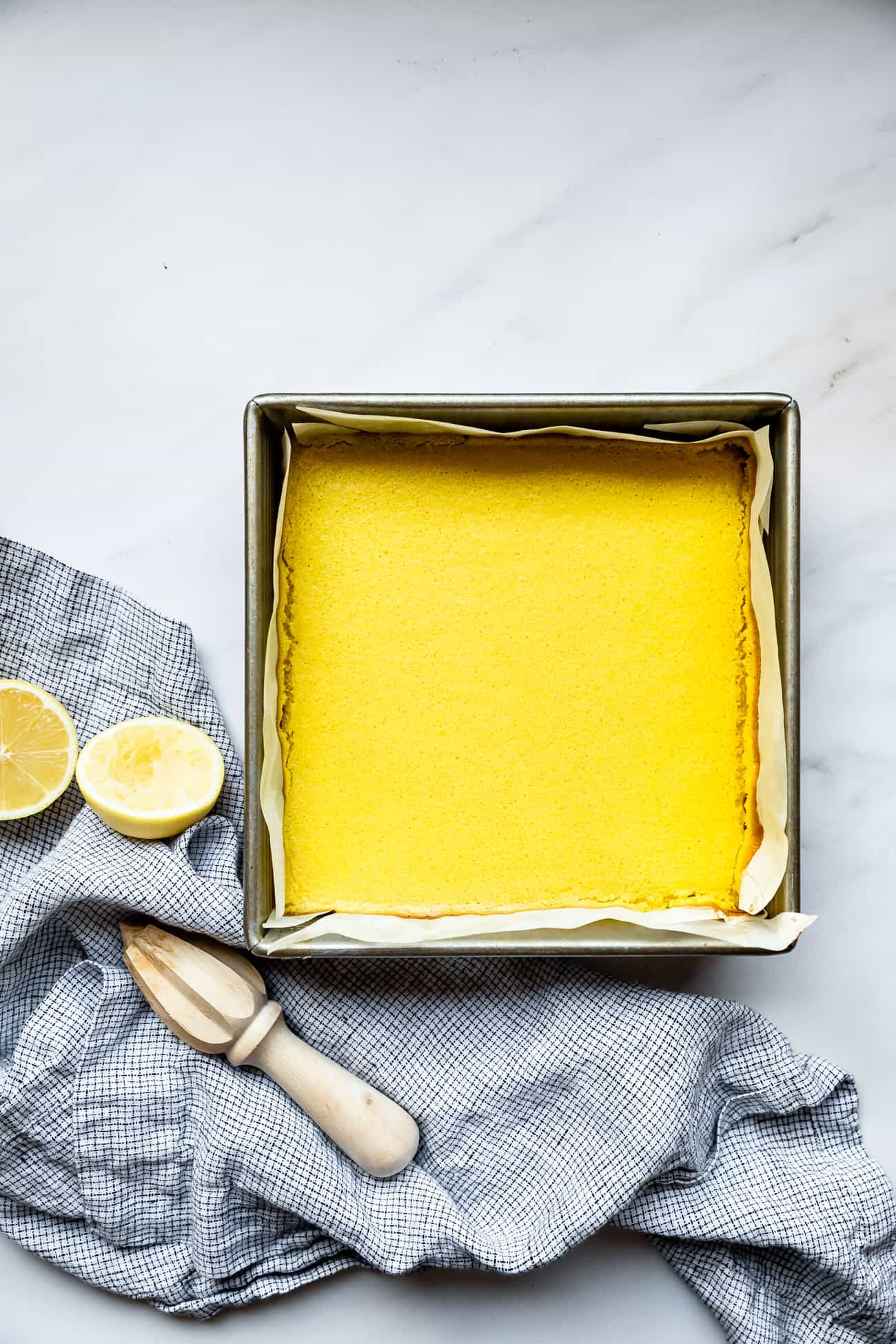 lemon bars in a baking pan before being sliced