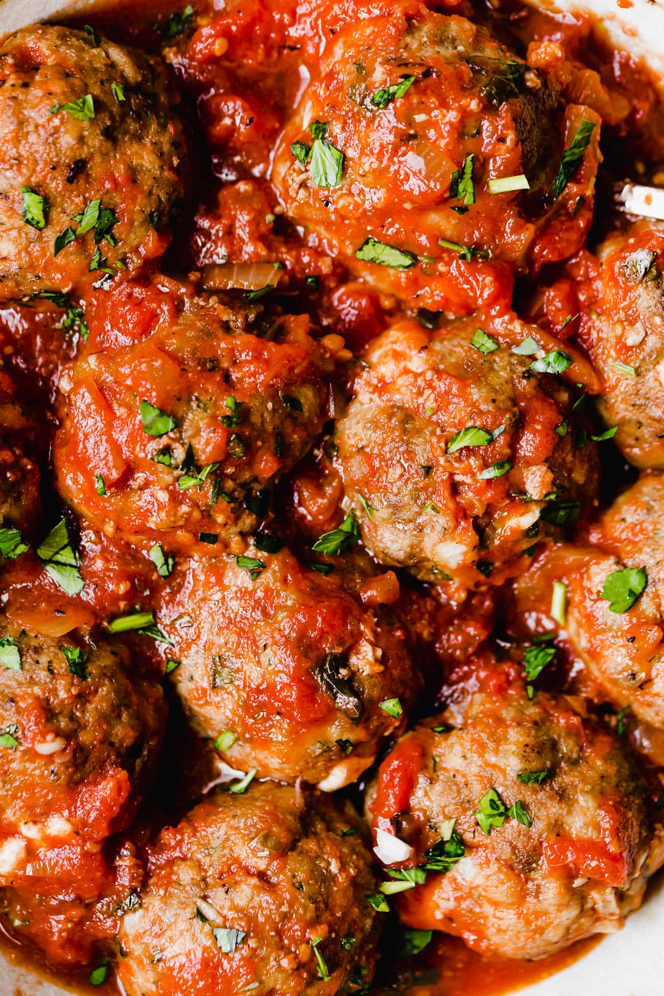 low carb mozzarella meatballs with red sauce and fresh parsley on top