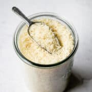 jasmine rice with a metal scoop in a glass jar
