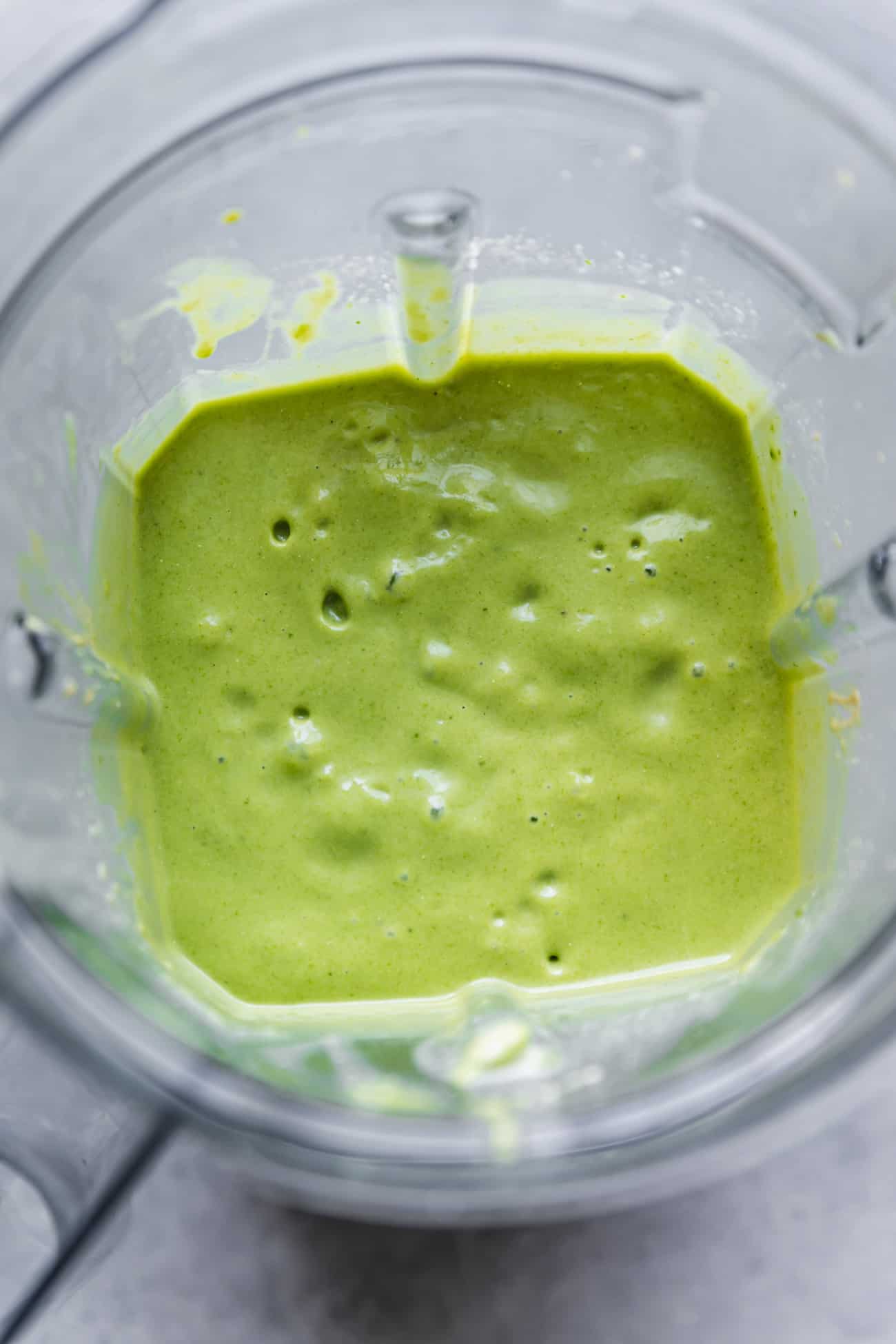 green smoothie blended in a blender pitcher