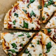 gluten free cheese pizza on brown parchment paper