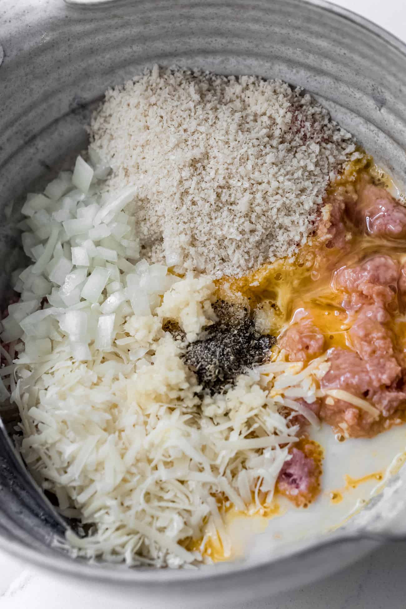 meatball ingredients all together in a ceramic bowl
