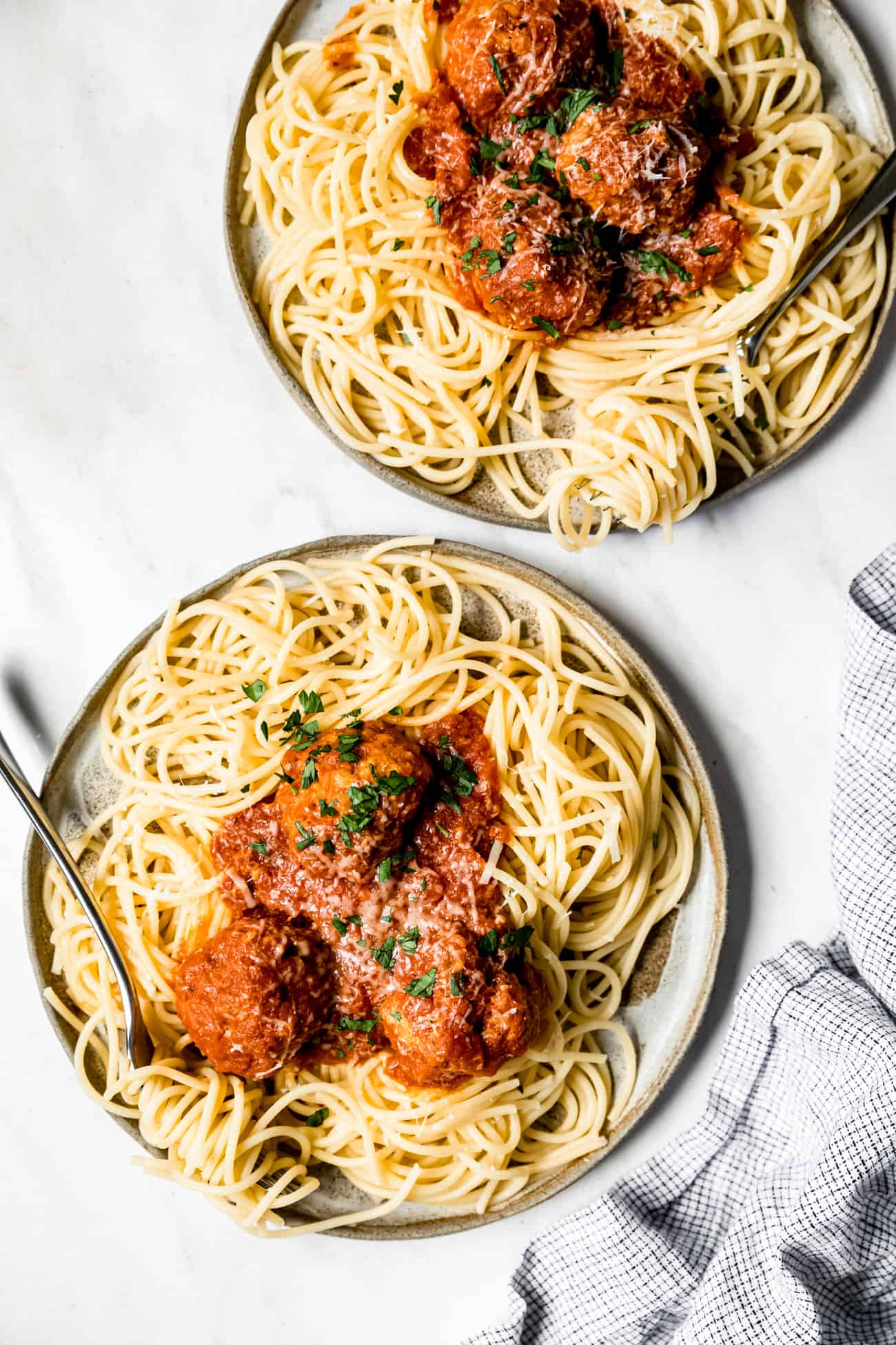 two plates of instant pot meatballs served with red sauce