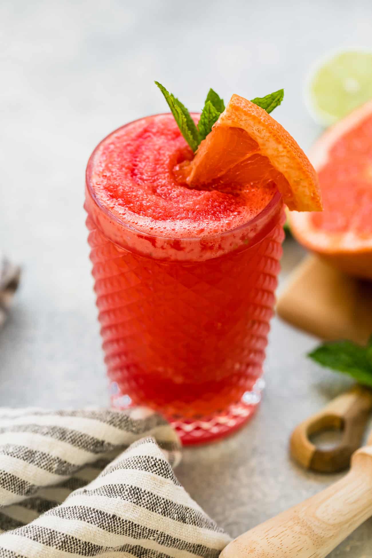 watermelon paloma in a glass with fresh mint and grapefruit garnish